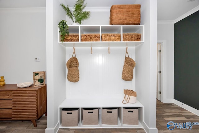 mudroom featuring baseboards, wood finished floors, and crown molding