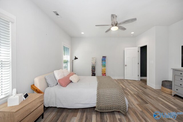 bedroom featuring recessed lighting, wood finished floors, ceiling fan, baseboards, and visible vents