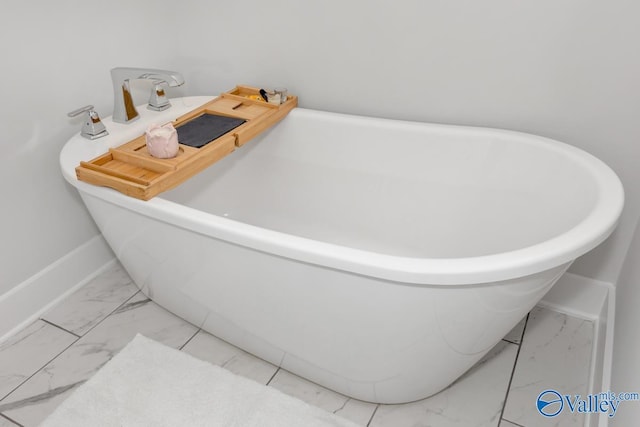 room details with a soaking tub and baseboards