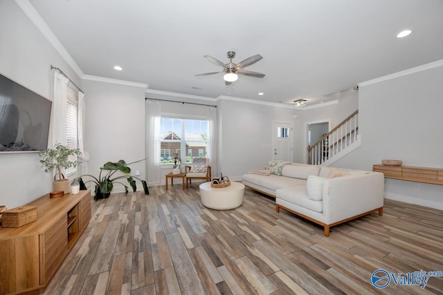 living area with recessed lighting, stairway, a ceiling fan, ornamental molding, and wood finished floors