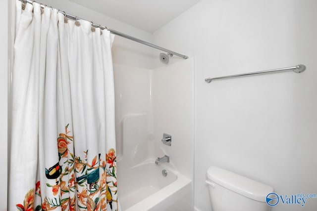 full bathroom with shower / bath combo with shower curtain and toilet