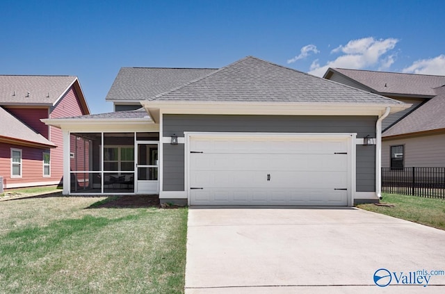 view of front facade with a sunroom, a shingled roof, concrete driveway, an attached garage, and fence