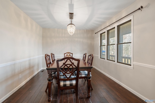 dining space featuring dark wood-type flooring