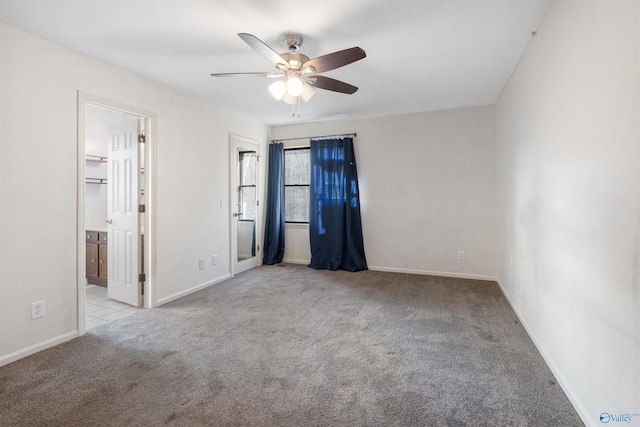 empty room featuring ceiling fan and light colored carpet