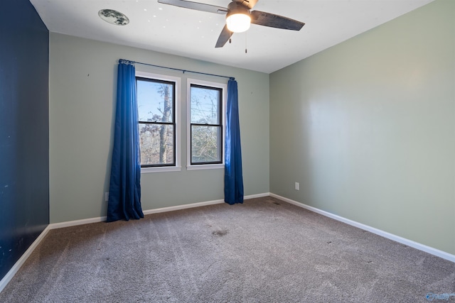 empty room with ceiling fan and carpet floors