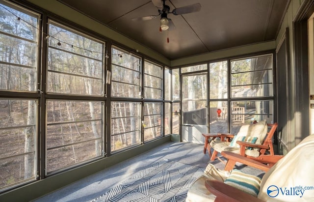 sunroom / solarium featuring ceiling fan