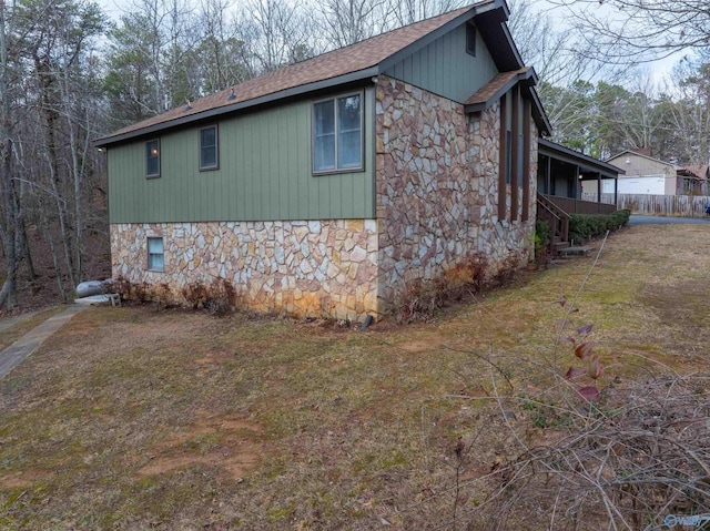 view of side of home with a lawn