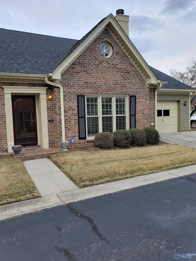 view of front of house with a front yard and a garage