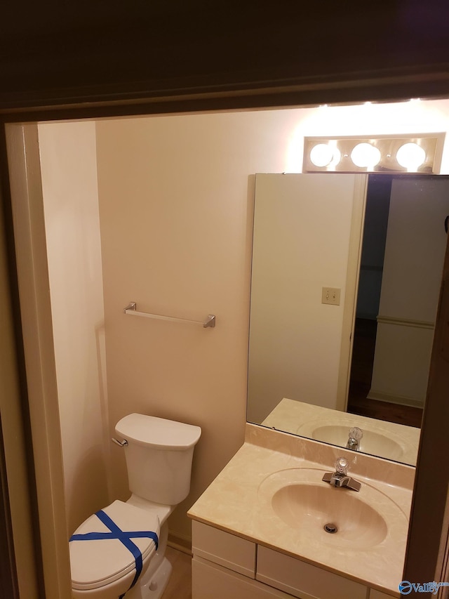 bathroom featuring vanity and toilet