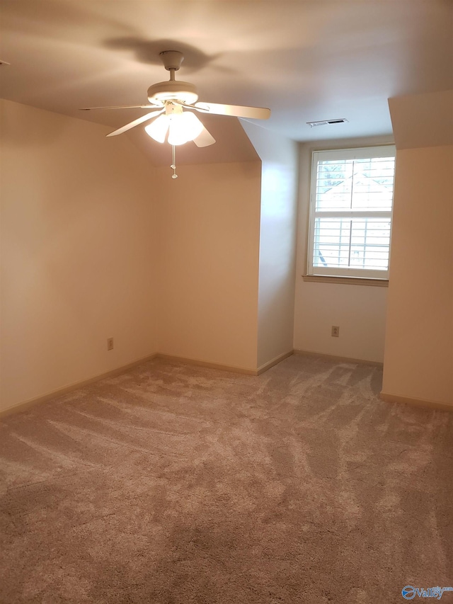 additional living space featuring ceiling fan and carpet