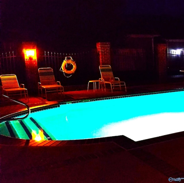 view of pool at night