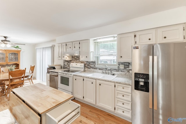 1108 Danmann Dr SE, Huntsville, AL 35803 - kitchen with stainless steel appliances, a sink, under cabinet range hood, and healthy amount of natural light