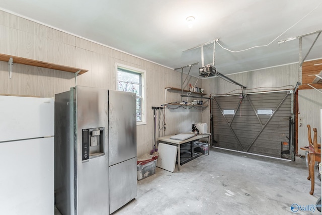 1108 Danmann Dr SE, Huntsville, AL 35803 - garage with freestanding refrigerator, stainless steel refrigerator with ice dispenser, and a garage door opener