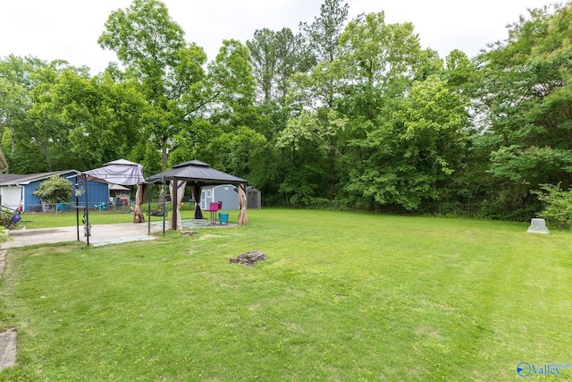 1108 Danmann Dr SE, Huntsville, AL 35803 - view of green lawn with a gazebo, a detached carport, and a patio