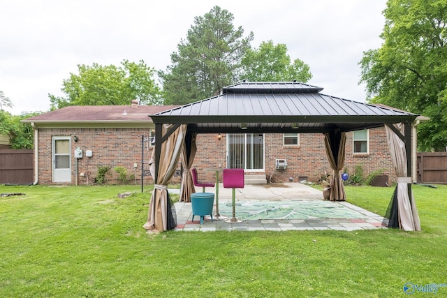 1108 Danmann Dr SE, Huntsville, AL 35803 - rear view of house featuring a gazebo, brick siding, a patio area, and a standing seam roof