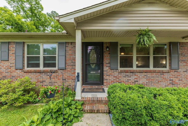 1108 Danmann Dr SE, Huntsville, AL 35803 - view of exterior entry featuring brick siding and a porch