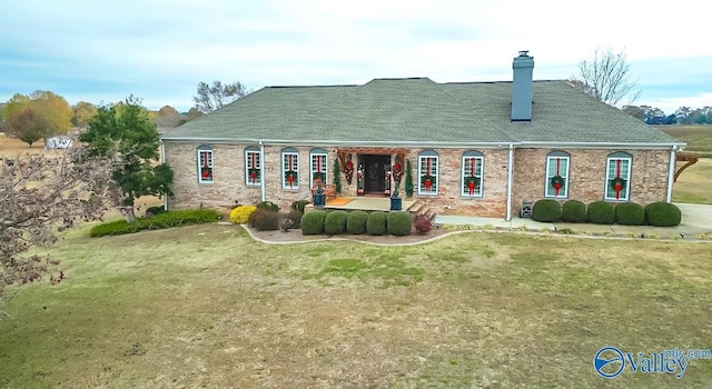 back of house with a lawn