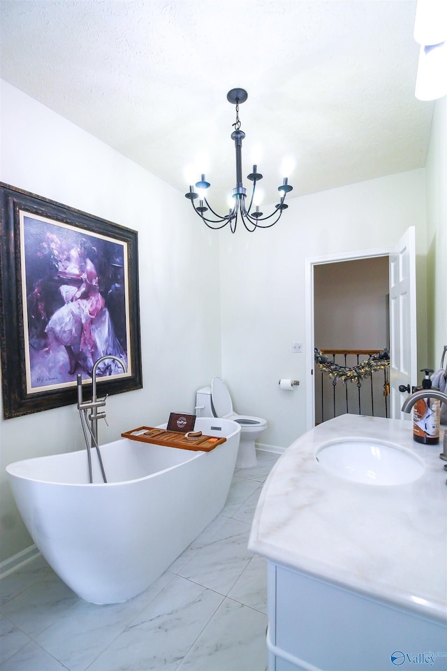 bathroom with a washtub, vanity, an inviting chandelier, and toilet