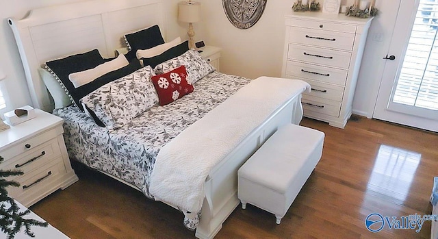 bedroom with dark hardwood / wood-style flooring