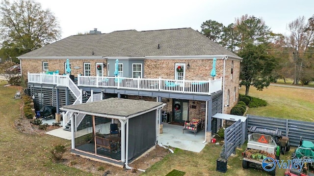 rear view of property featuring a yard and a patio