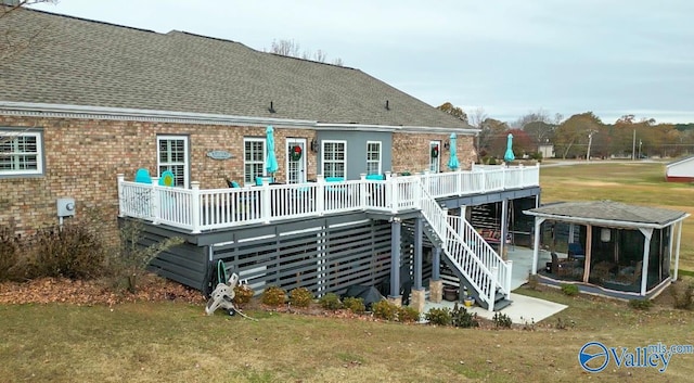 back of house featuring a yard and a deck