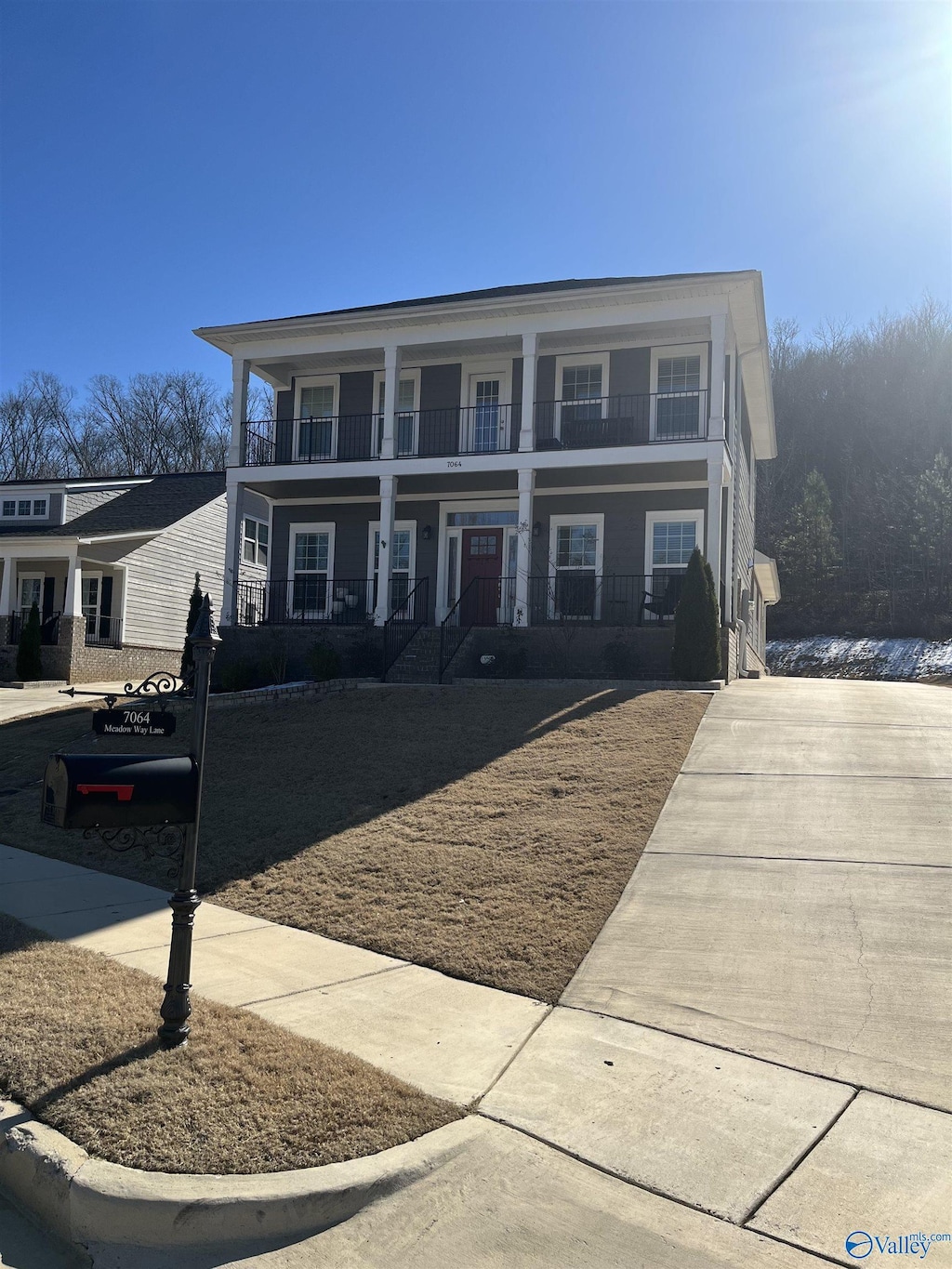 view of front of property with covered porch and a balcony