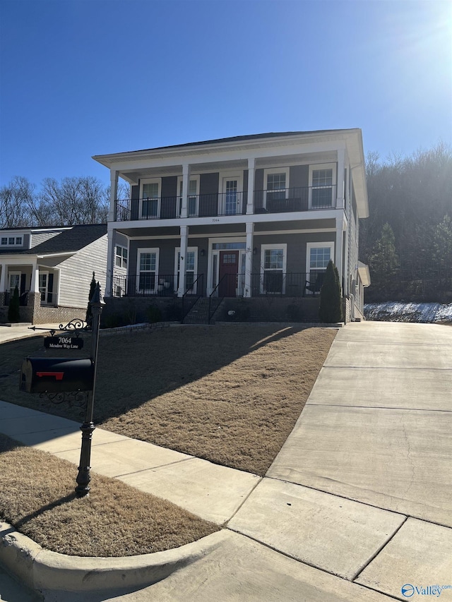 view of front of property with a balcony and covered porch