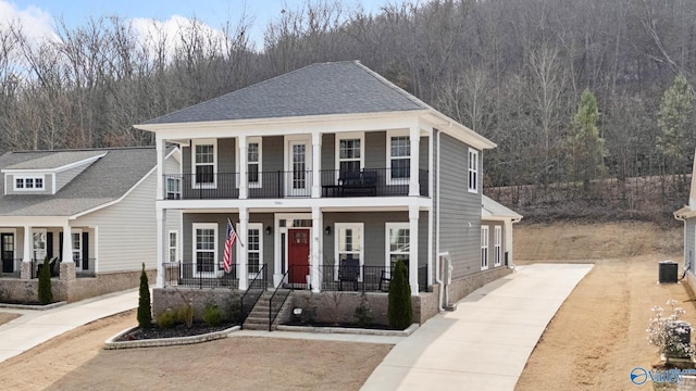 view of front of home featuring a balcony, central AC, and covered porch