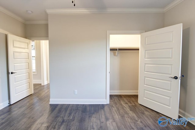 unfurnished bedroom with ornamental molding, dark wood-type flooring, and a closet