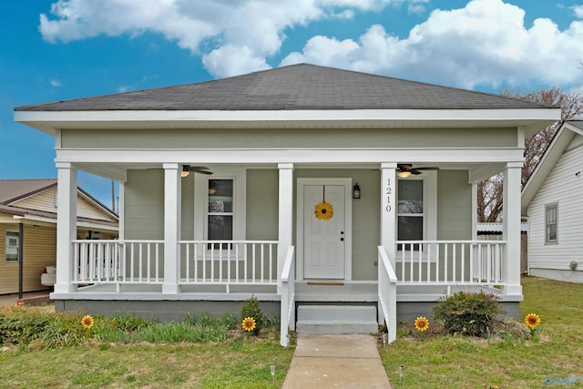 view of front facade with a shingled roof, covered porch, and ceiling fan