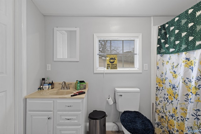 bathroom featuring curtained shower, vanity, and toilet