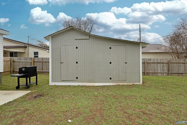 view of shed with a fenced backyard