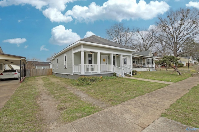 view of front of home featuring a porch, fence, driveway, crawl space, and a front lawn