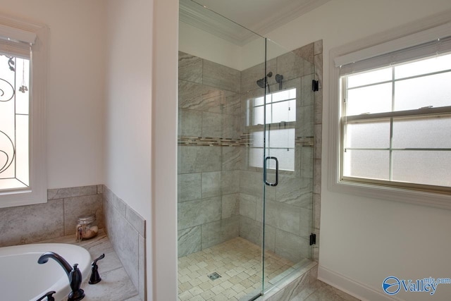 bathroom with ornamental molding, a stall shower, a garden tub, and a healthy amount of sunlight