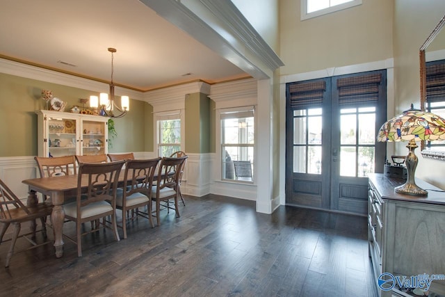 dining room with french doors, dark wood-style flooring, wainscoting, and a notable chandelier