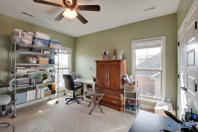 carpeted home office with visible vents and a ceiling fan