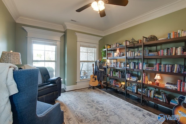 sitting room with crown molding, visible vents, ceiling fan, wood finished floors, and baseboards