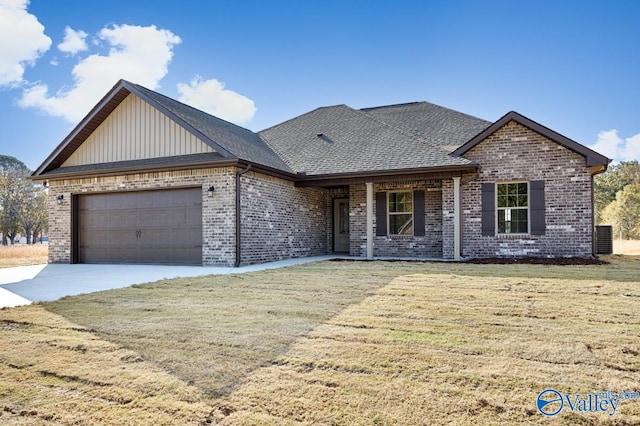 view of front of home featuring a front yard and a garage