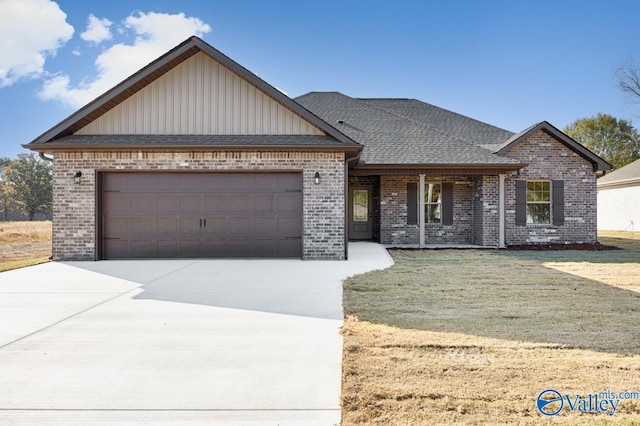 view of front of property featuring a front yard and a garage