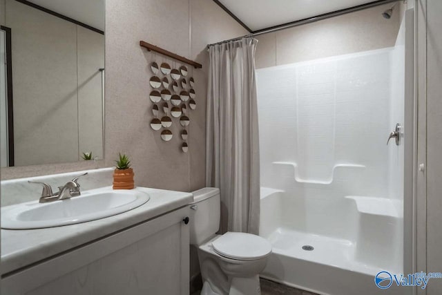 bathroom with toilet, vanity, and a shower with shower curtain