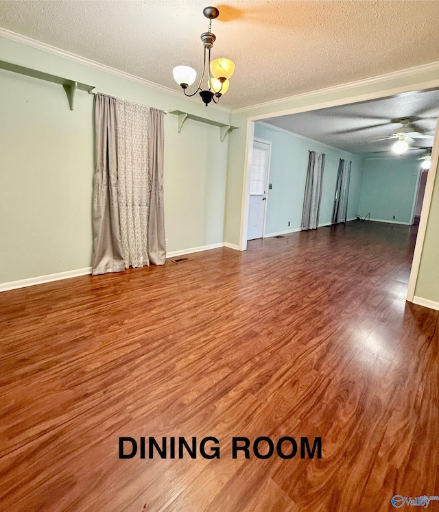 empty room with hardwood / wood-style floors, ceiling fan with notable chandelier, ornamental molding, and a textured ceiling