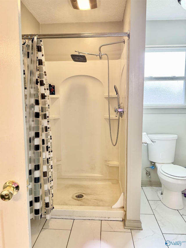 bathroom featuring toilet and a shower with shower curtain