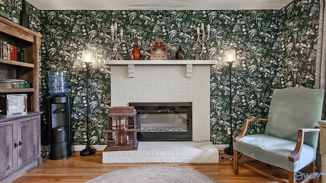 living area featuring a fireplace and wood-type flooring