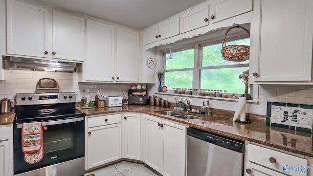 kitchen featuring white cabinets, range hood, and appliances with stainless steel finishes