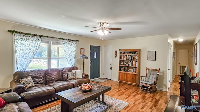 living room with ceiling fan and light hardwood / wood-style flooring