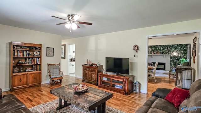 living room with ceiling fan and hardwood / wood-style floors