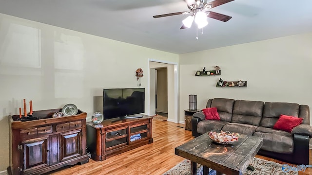 living room featuring light hardwood / wood-style floors and ceiling fan