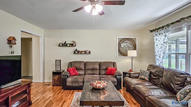 living room with ceiling fan and light wood-type flooring