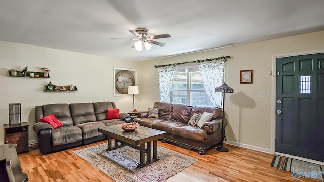 living room featuring hardwood / wood-style floors and ceiling fan