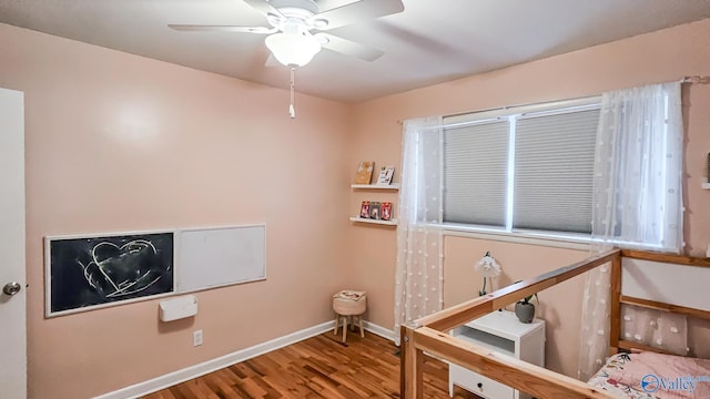 bedroom with ceiling fan and hardwood / wood-style flooring